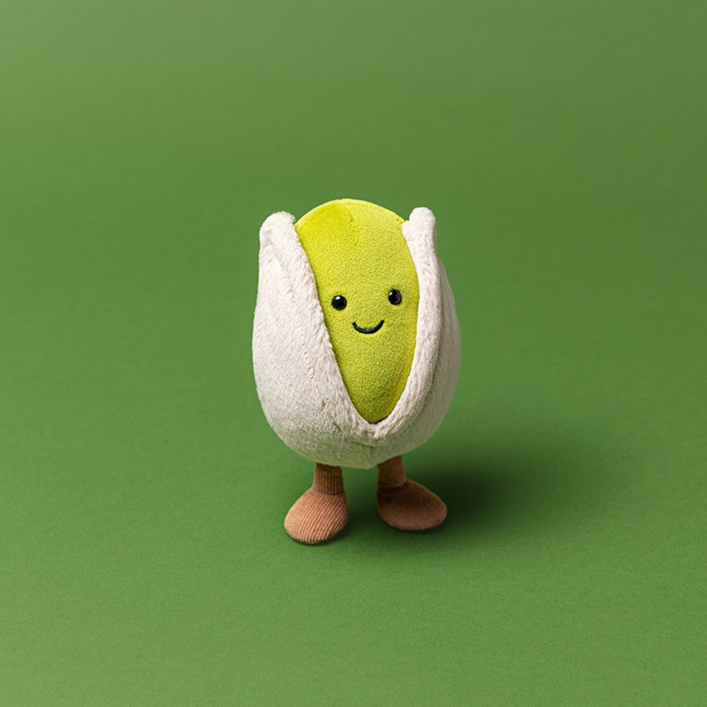 Plush toy of a pistachio on a green background