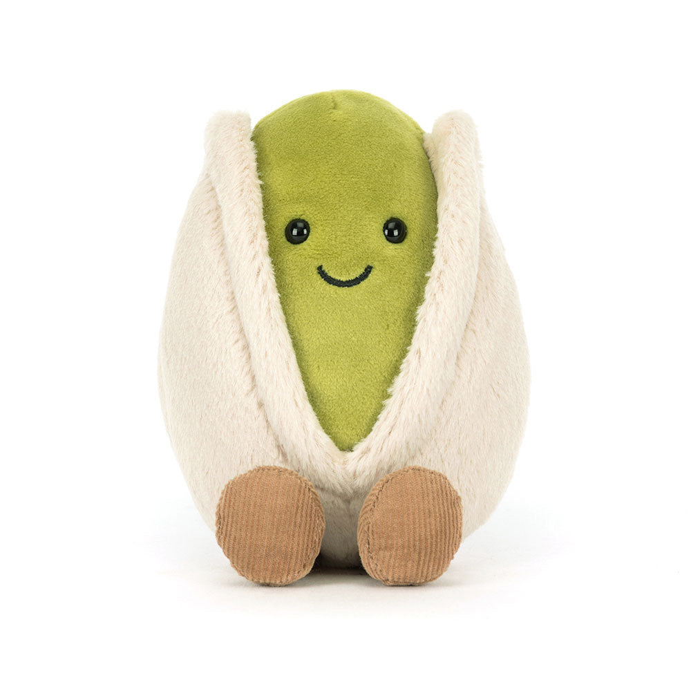 Jellycat plush toy shaped like a pistachio avocado with a smiling face on a white background