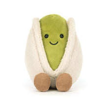 Jellycat plush toy shaped like a pistachio avocado with a smiling face on a white background