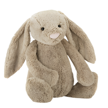 A beige plush toy rabbit with a soft texture, sitting upright.