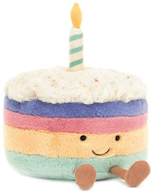 Plush toy cake with a candle on a white background