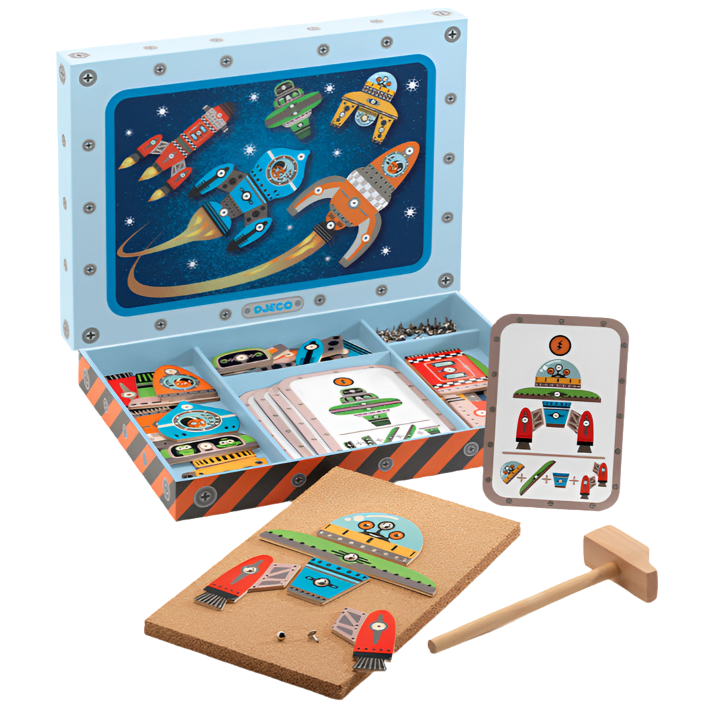 A Space themed hammer tap game set by Djeco, including printed wooden tiles, a wooden mallet, tacks, and inspiration cards, all presented in a wooden box with space-themed artwork.