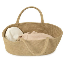 A beige rope carry cot for dolls, featuring a cotton mattress, cushion, and blanket.