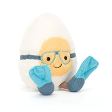 A plush toy resembling a boiled egg with super-soft white and yellow fur, blue embroidered goggles, and blue suedette flippers.
