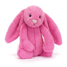 A medium-sized plush toy in the shape of a hot pink bunny with long ears.