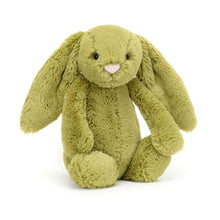 A plush toy resembling a lop-eared bunny with a moss green body, a soft tummy, and a silky vanilla bobtail.