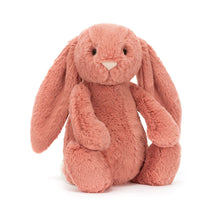 A plush toy resembling a sorrel colored bunny with long ears, a silky bobtail, and a nose detail.