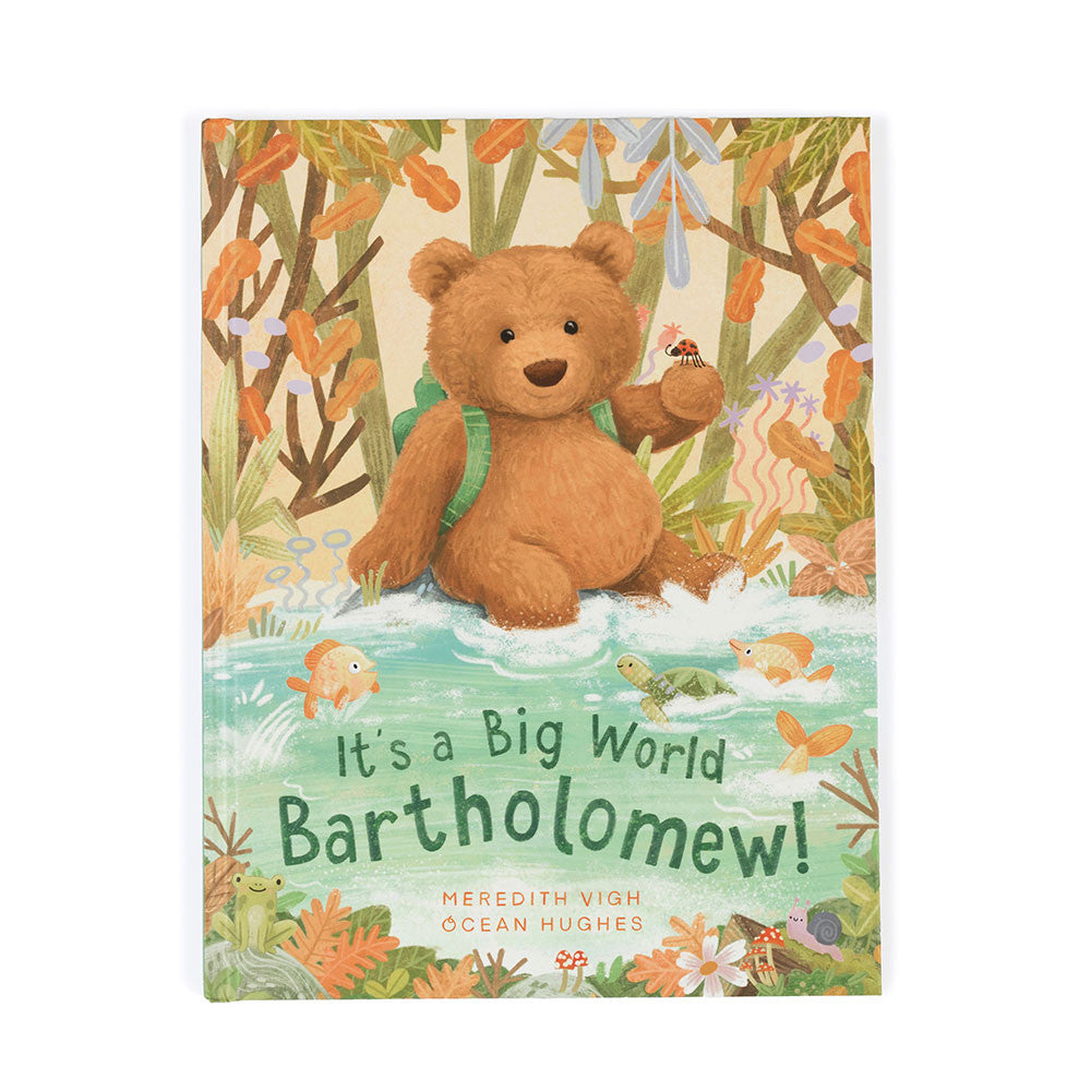 A hardback children's book cover featuring an illustration of a brown bear with a green backpack sitting in front of a forest backdrop. The title 'It's a Big World Bartholomew!' is displayed at the top.