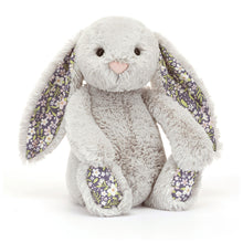 A plush toy depicting a silver bunny with floral ears and feet, against a white background.