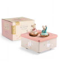 A pastel pink and cream music box with two dancing mouse figurines, shown alongside its branded retail box on a clean white background.