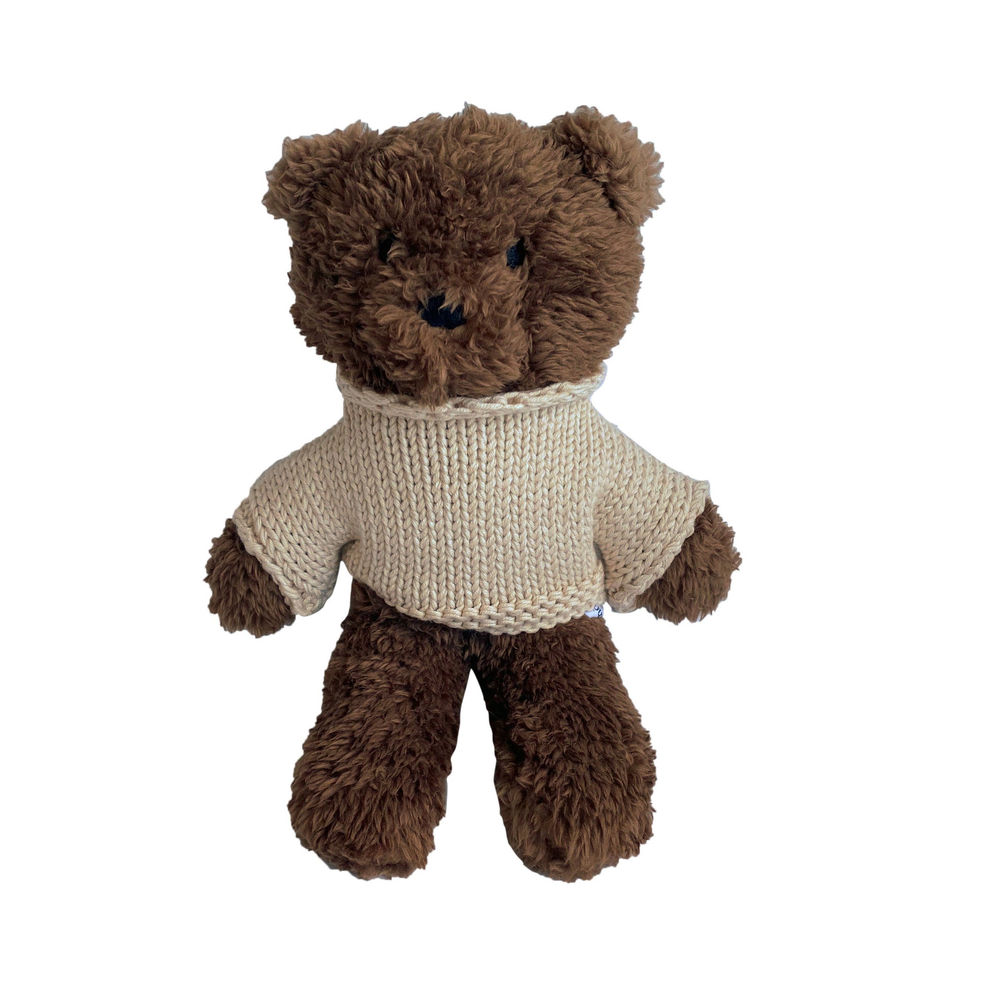 Brown teddy bear wearing a beige sweater on a white background