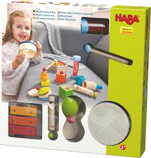 A 12-piece music maker set by HABA, including various musical instruments and sound effect toys displayed around the package.