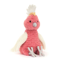 Pink plush toy with white accents on a white background