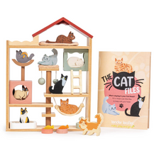 Cat toy set with a wooden house structure and cat-themed accessories on a white background.