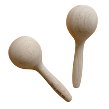 Love Note Co natural wooden maracas for children on a warm white background.