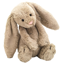A beige plush toy rabbit with long ears and a soft fur texture, sitting upright.