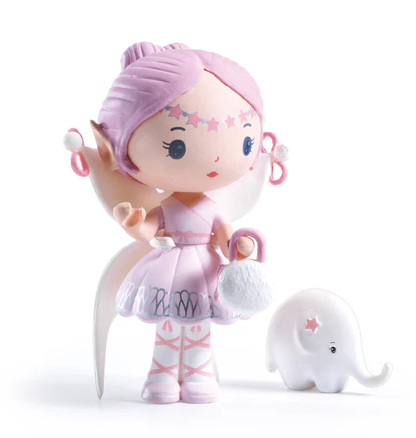 Toy figure with pink hair and dress, standing next to a small white elephant on a white background
