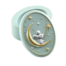 A small, oval-shaped mint green resin tooth box with an illustration of a 3D mouse sitting on the moon, surrounded by gold and silver stars.