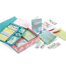 A box set of children's stationery with pink and blue cloud design, including various cards and envelopes with decorative elements.