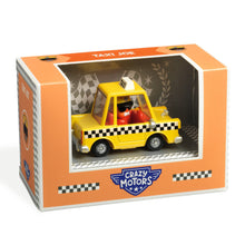 A toy taxi cab in yellow with black and white checkered patterns, resembling a New York city cab, named 'Taxi Joe' from Crazy Motors, displayed in its packaging.