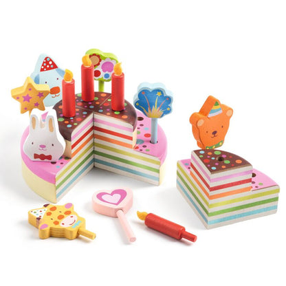 Colorful toy cake set with candles and decorations on a white background