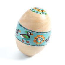 An egg-shaped wooden maraca with a colorful pattern featuring birds and floral designs.