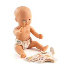 Baby doll with a diaper and another diaper on a white background