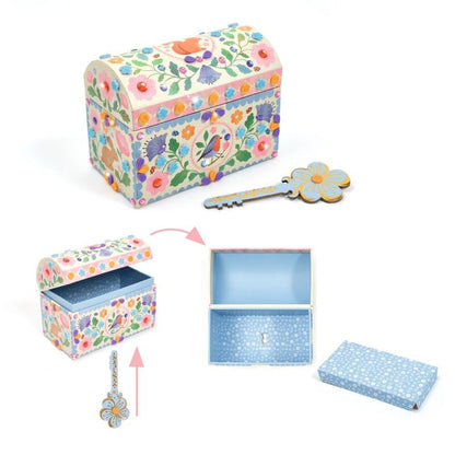 Decorative jewelry box with floral pattern, key, and open lid on a white background