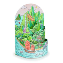 Colorful paper craft of a tropical landscape with mountains, water, and animals on a white background.