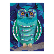 Decorative owl with beaded details on a blue background