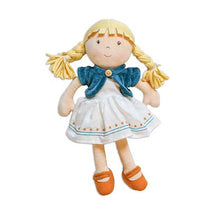 A beige-colored doll with a blue dress, white apron, and orange shoes. The doll has a removable dress and underpants, and features a soft body and a happy facial expression.