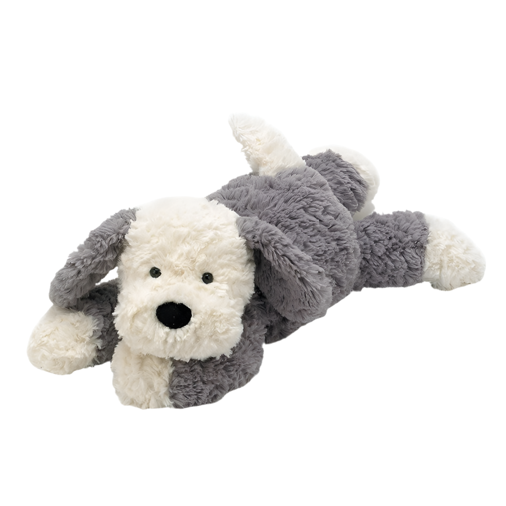 A soft, plush sheep dog toy with gray and cream fur and a velvety black nose, lying down.