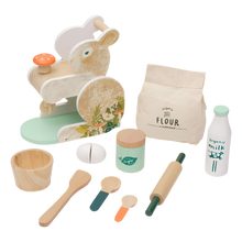 A wooden bunny-themed baking set including a bunny-shaped mixer, a bowl, spoons, a rolling pin, a spatula, a sugar jar, a milk bottle, a flour bag, and pretend food items.