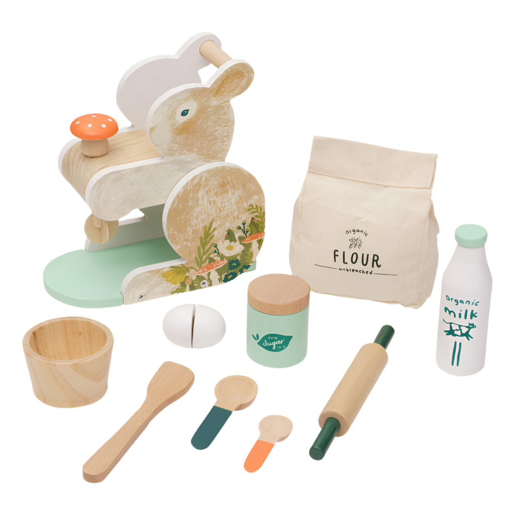 A wooden bunny-themed baking set including a bunny-shaped mixer, a bowl, spoons, a rolling pin, a spatula, a sugar jar, a milk bottle, a flour bag, and pretend food items.