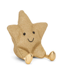 A plush toy shaped like a star with beige body and gold-colored accents on the limbs and a smiling face.