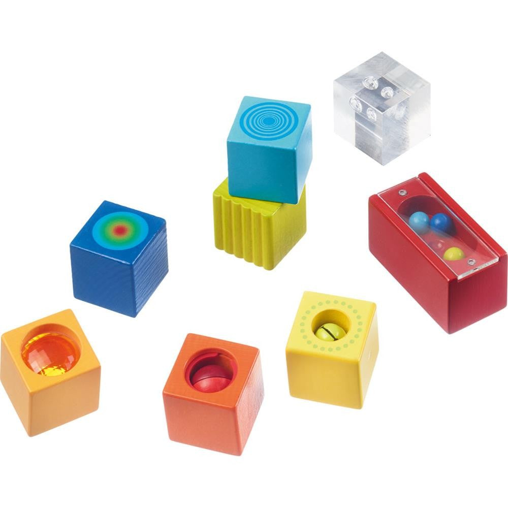 A set of colorful wooden blocks, each with a different sound effect or visual feature designed for toddler learning and play.
