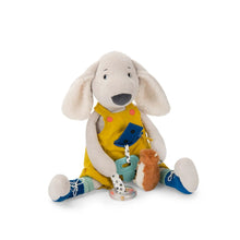 Cream coloured activity go, floppy ears, wearing yellow overalls, dark blue stitched shoes