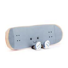 Light blue skateboard shaped Jellycat soft toy with smiling face and dangle legs.