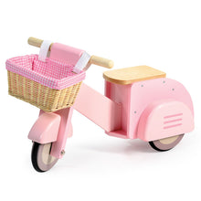 Pink wooden toy scooter with a pink gingham lined rattan basket on a white background
