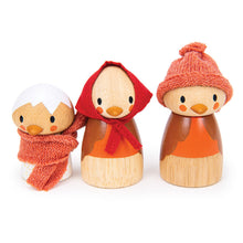 Three cute wooden bird dolls with colorful hats and scarves on a white background