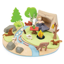 Wooden playset with a wooden child doll  in a tent, animals, and nature elements on a white background