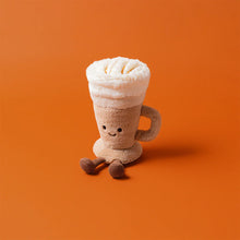 Plush toy resembling a coffee cup with whipped cream on an orange background