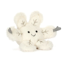 White plush snow flake toy with silver accents on a white background