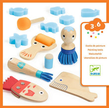 Set of wooden painting tools for children with various shapes and a figure, branded as Djeco.