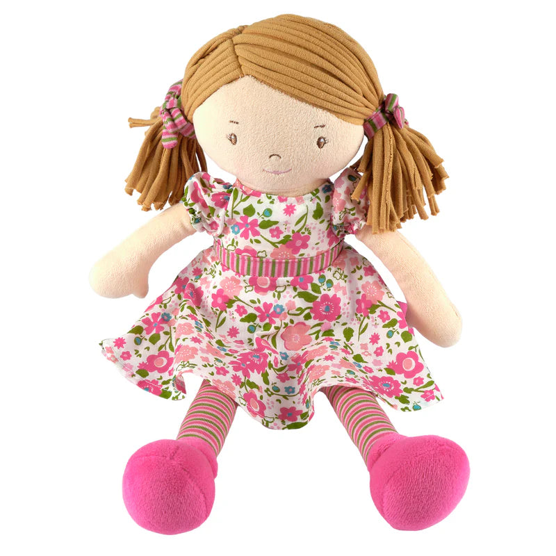 Plush doll with a floral dress and pink shoes on a white background