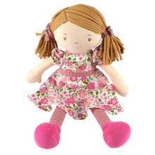 Plush doll with a floral dress and pink shoes on a white background