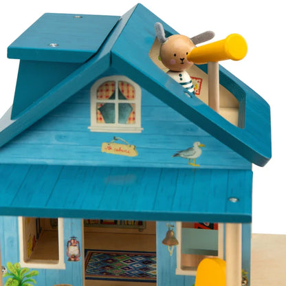 Toy house with a teddy bear character on top, set against a white background