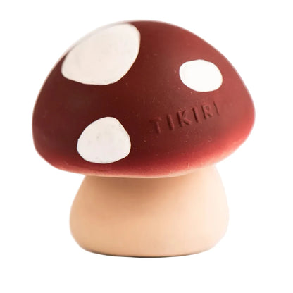 Mushroom-shaped toy with white spots on a light background
