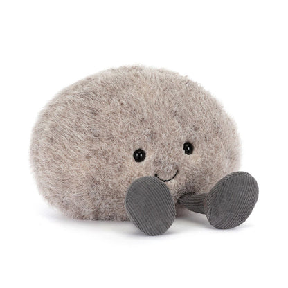 Plush toy resembling a round grey pebble with a smiling face on a white background