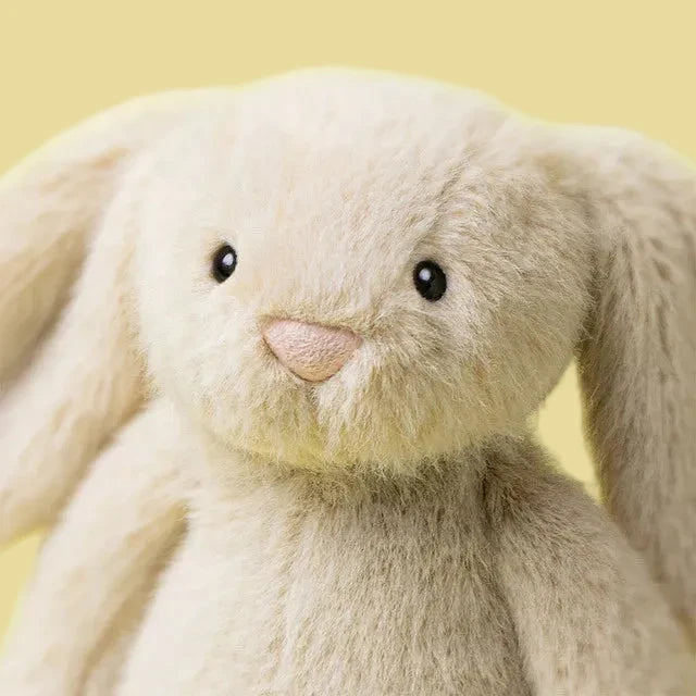 Close-up of a plush bunny toy with a yellow background